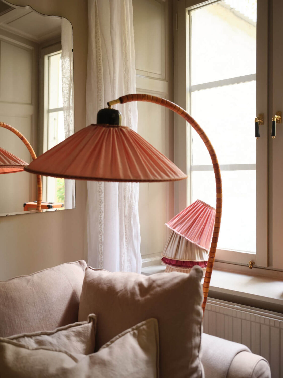 A Charming Vintage Apartment with Historic Wallpapers in Stockholm 2 arched pink lamp
