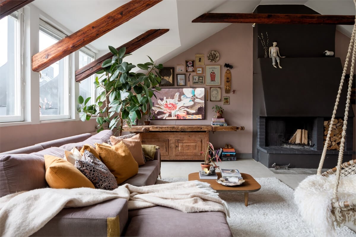 A Colorful Family Attic Apartment in Stockholm 2 attic living room exposed wooden beams fireplace