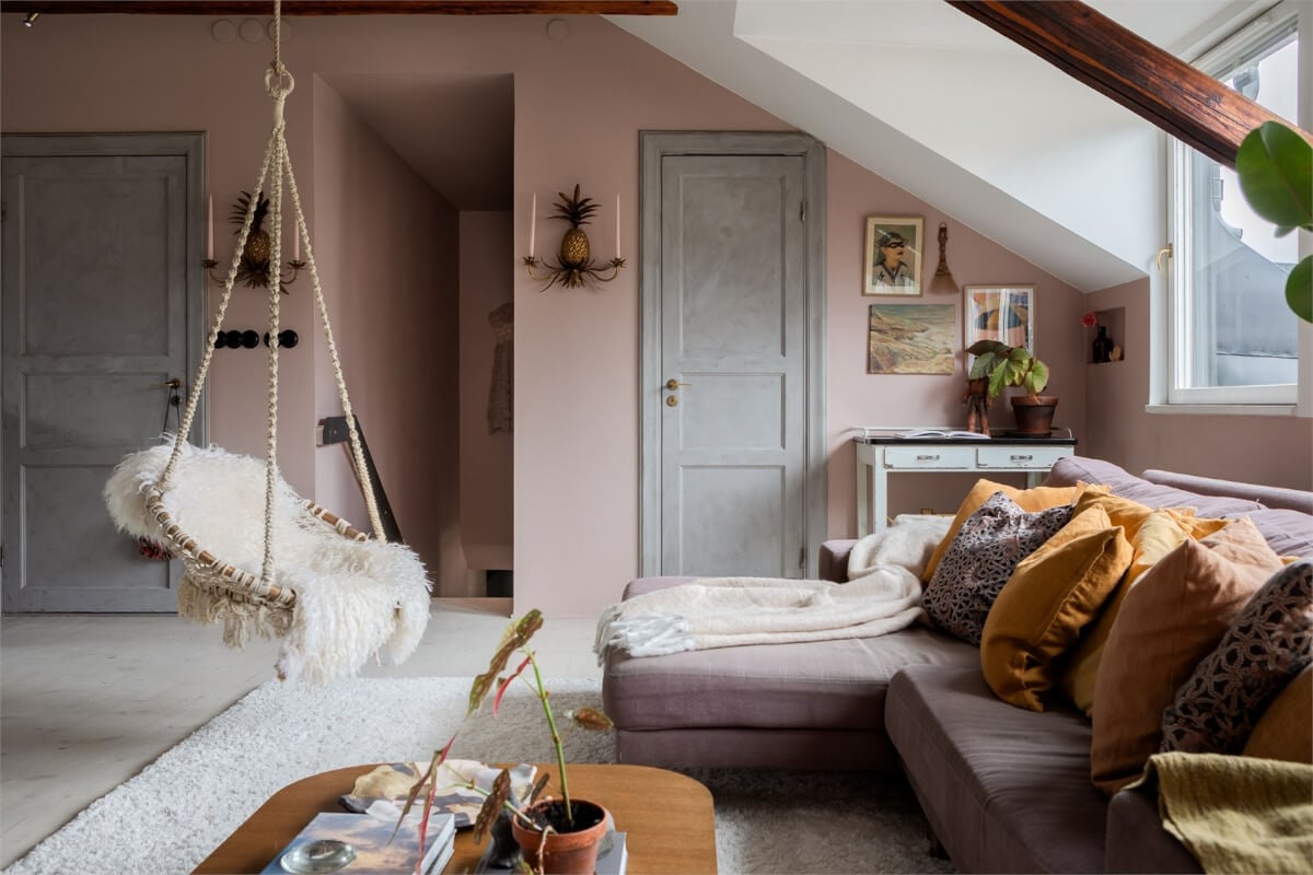A Colorful Family Attic Apartment in Stockholm 3 attic living room hanging chair pink walls