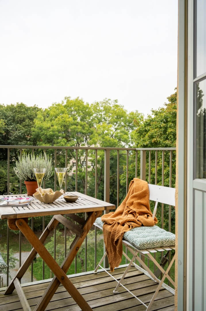 A Light Swedish Apartment with a Green Living Room 11 balcony park view