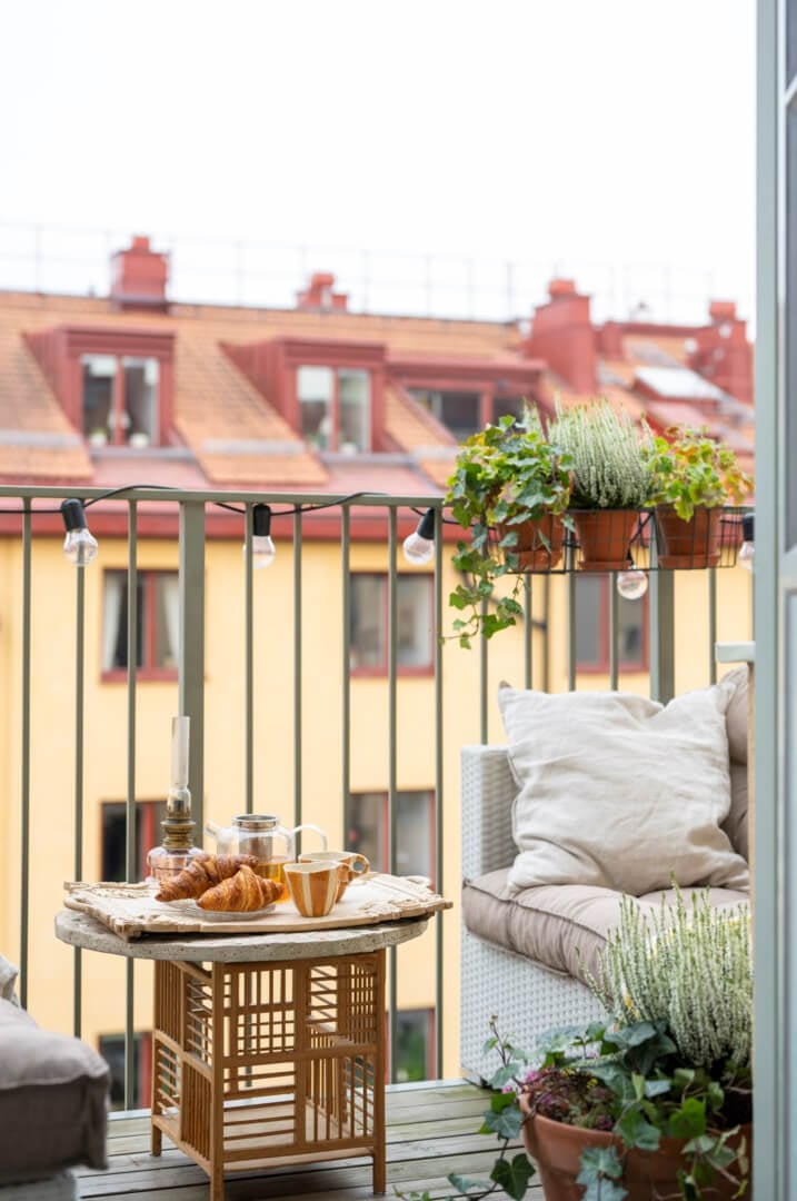 A Light Swedish Apartment with a Green Living Room 21 balcony with sofas