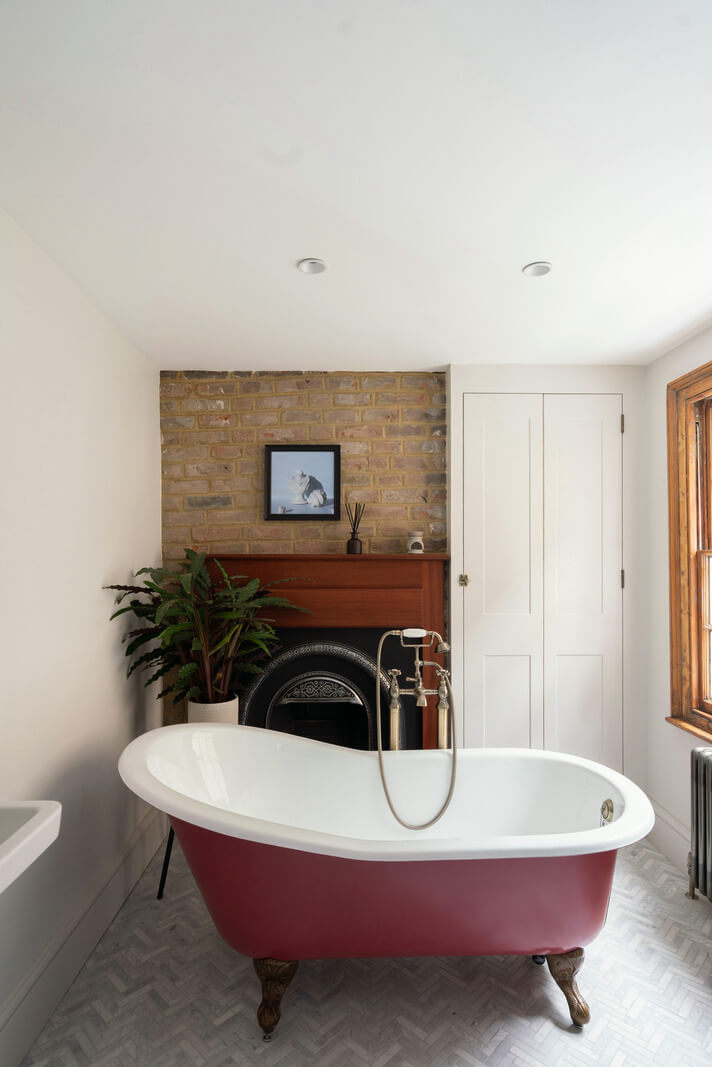 A Renovated Georgian House with an Extended Kitchen 25 bathroom dark pink clawfoot bath fireplace