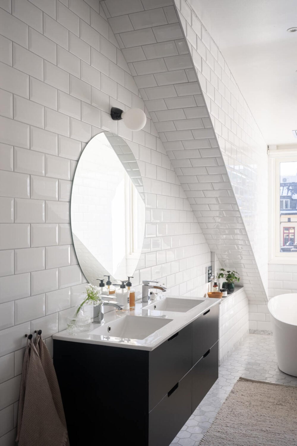 A Light Penthouse Apartment with Built-In Bookshelves 20 bathroom double sink large round mirror