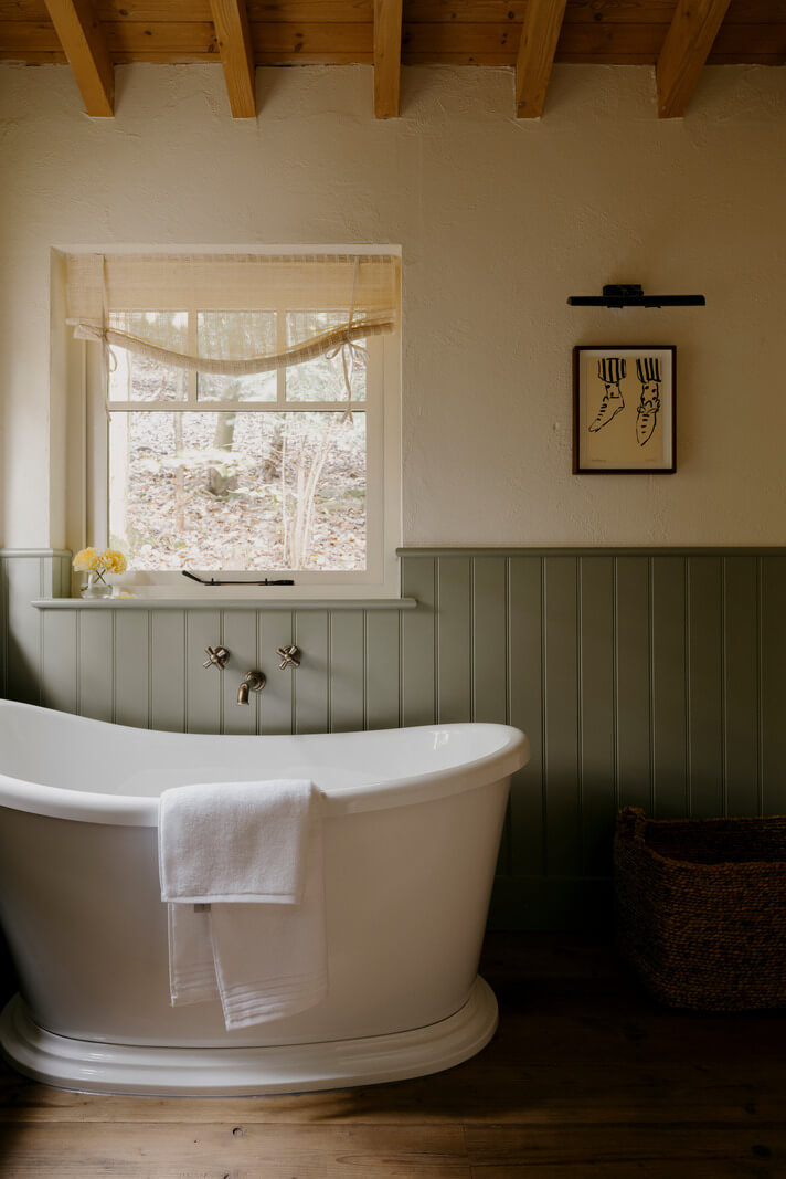 A Cozy and Contemporary Take on a Traditional Log House 17 bathroom freestanding bath tongue and groove paneling
