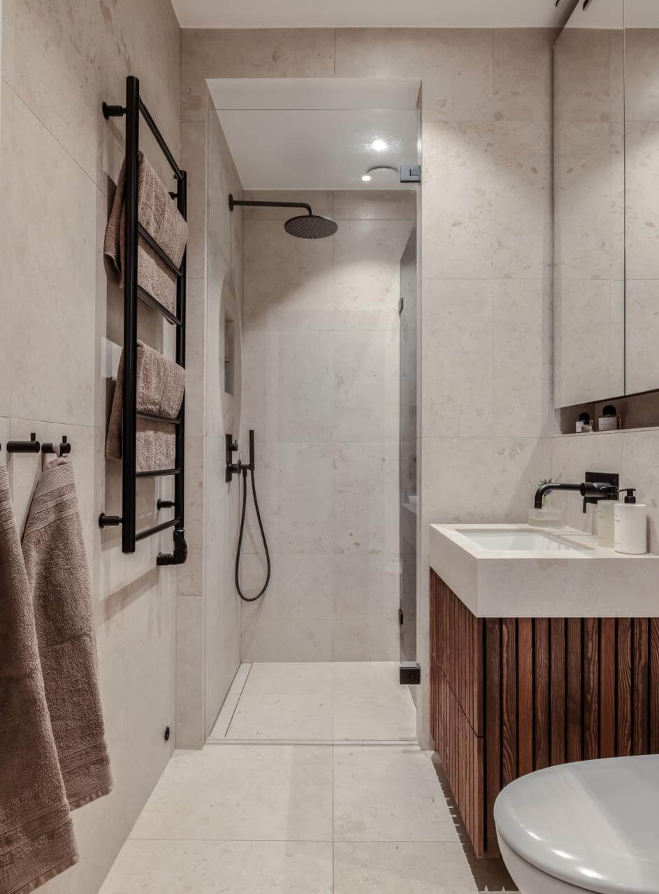 Pastel Colors and Contemporary Design in a Late 19th Century Apartment 18 bathroom-gray-tiles-walnut-cabinet