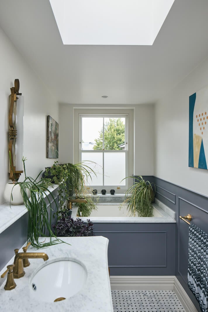 A Renovated Early Victorian Townhouse Decorated in Green Tones 16 bathroom with skylight and blue woodwork
