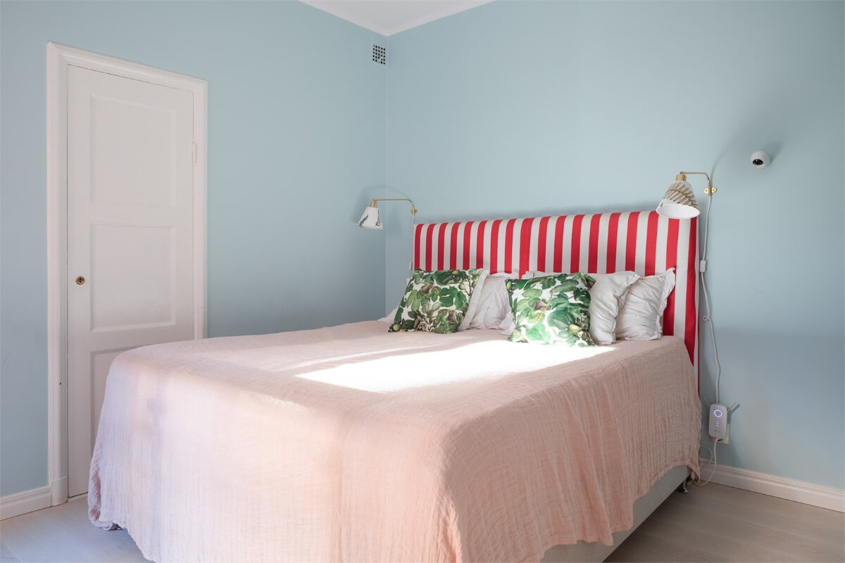 A Colorful Basement Duplex Apartment in Stockholm 16 bedroom light blue walls striped red headboard
