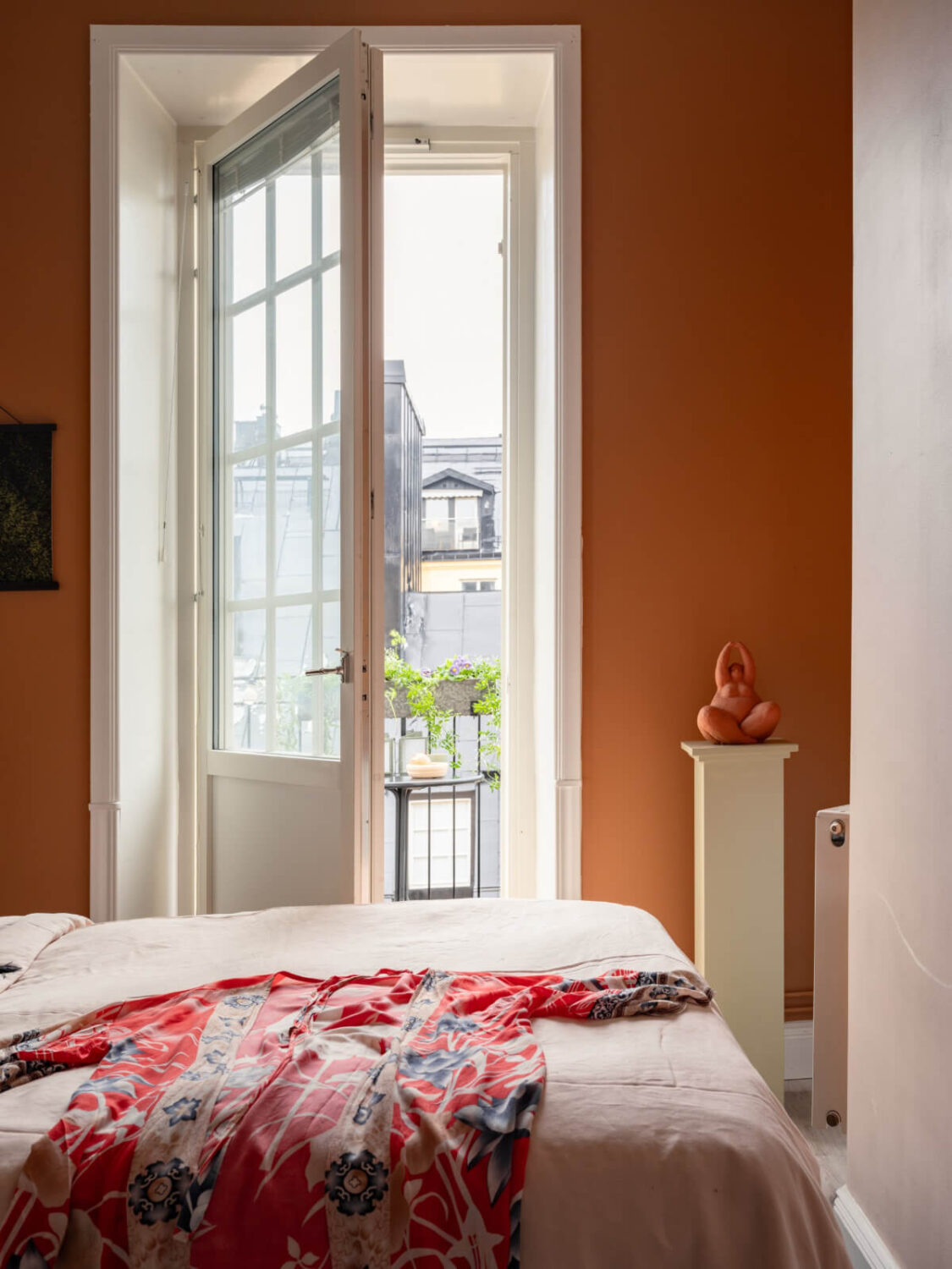 A Pink and Orange Bedroom in a Light Stockholm Apartment 16 bedroom orange wall balcony door