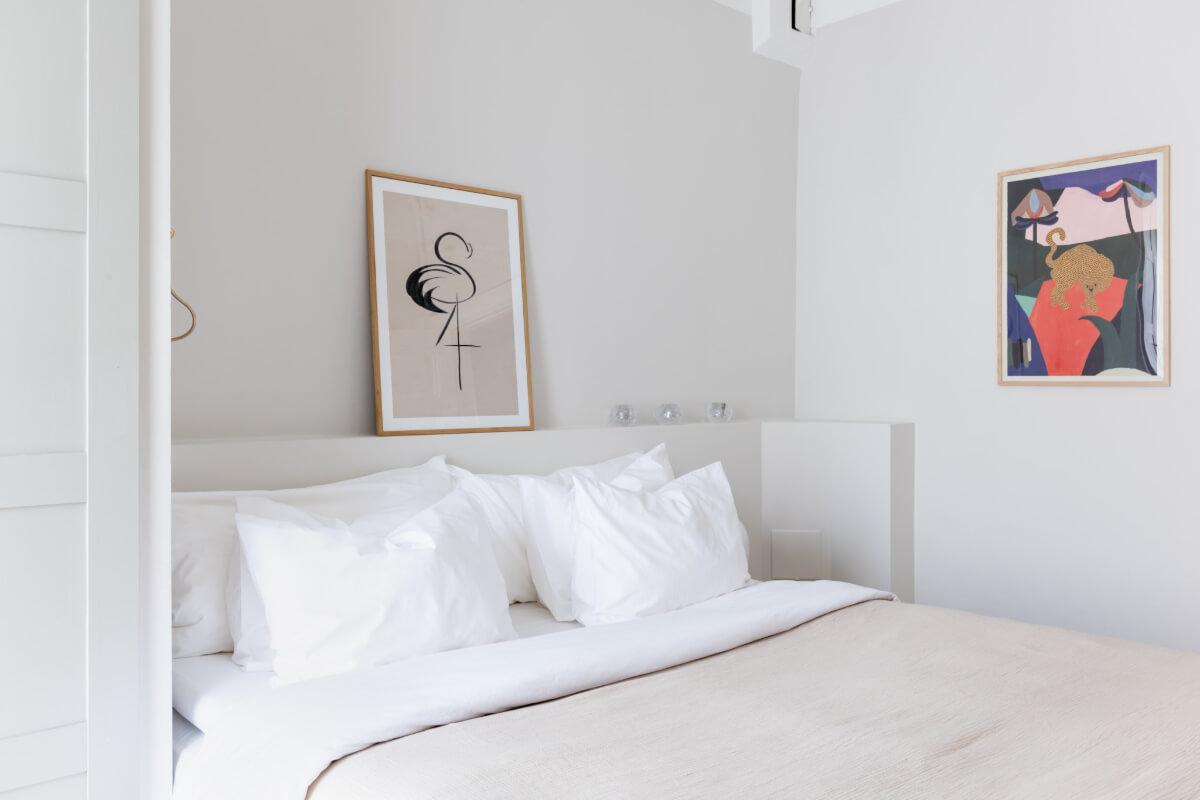 A Small Apartment Decorated in a Light Gray & White Color Palette 18 bedroom storage ledge