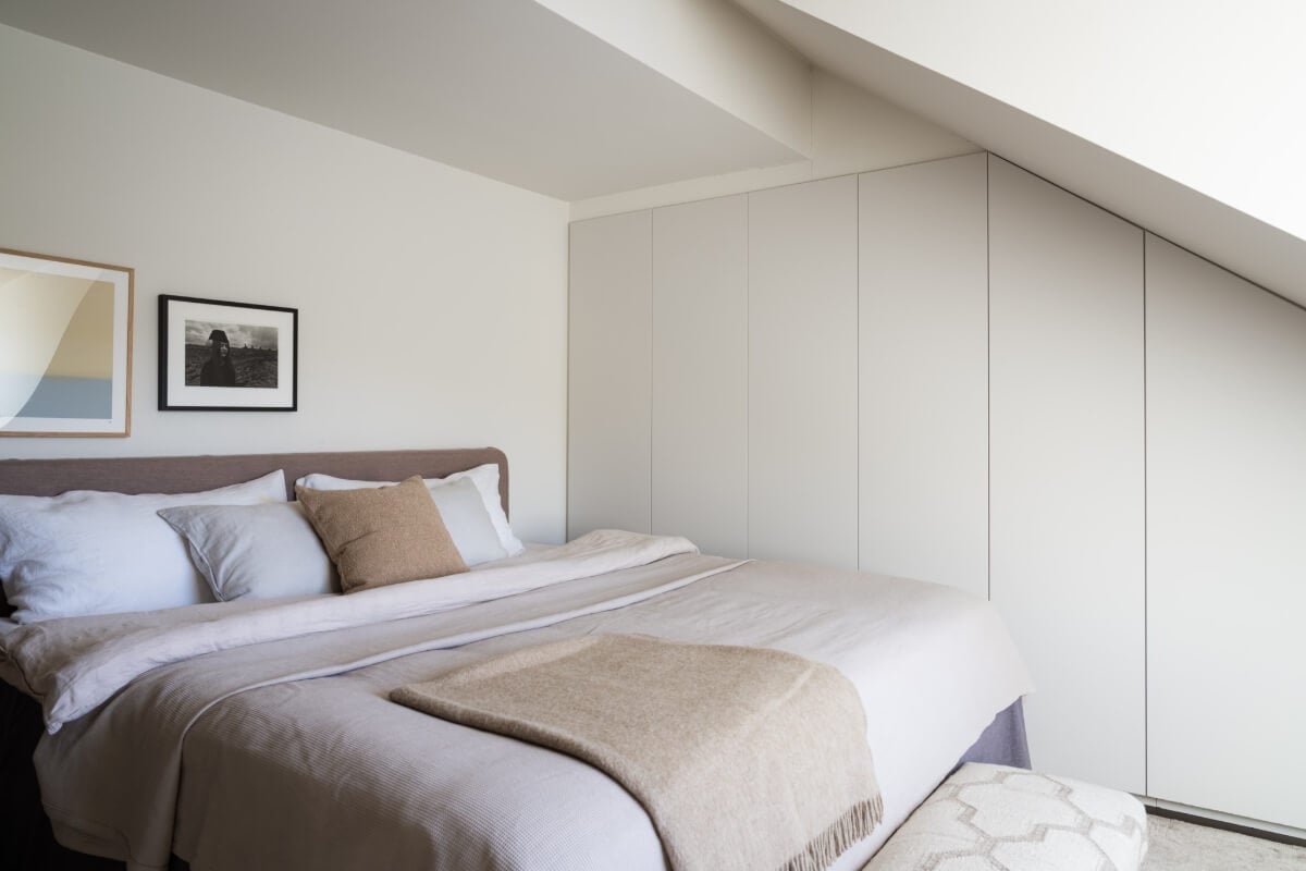 A Light Penthouse Apartment with Built-In Bookshelves 16 bedroom wardrobes under slanted ceiling