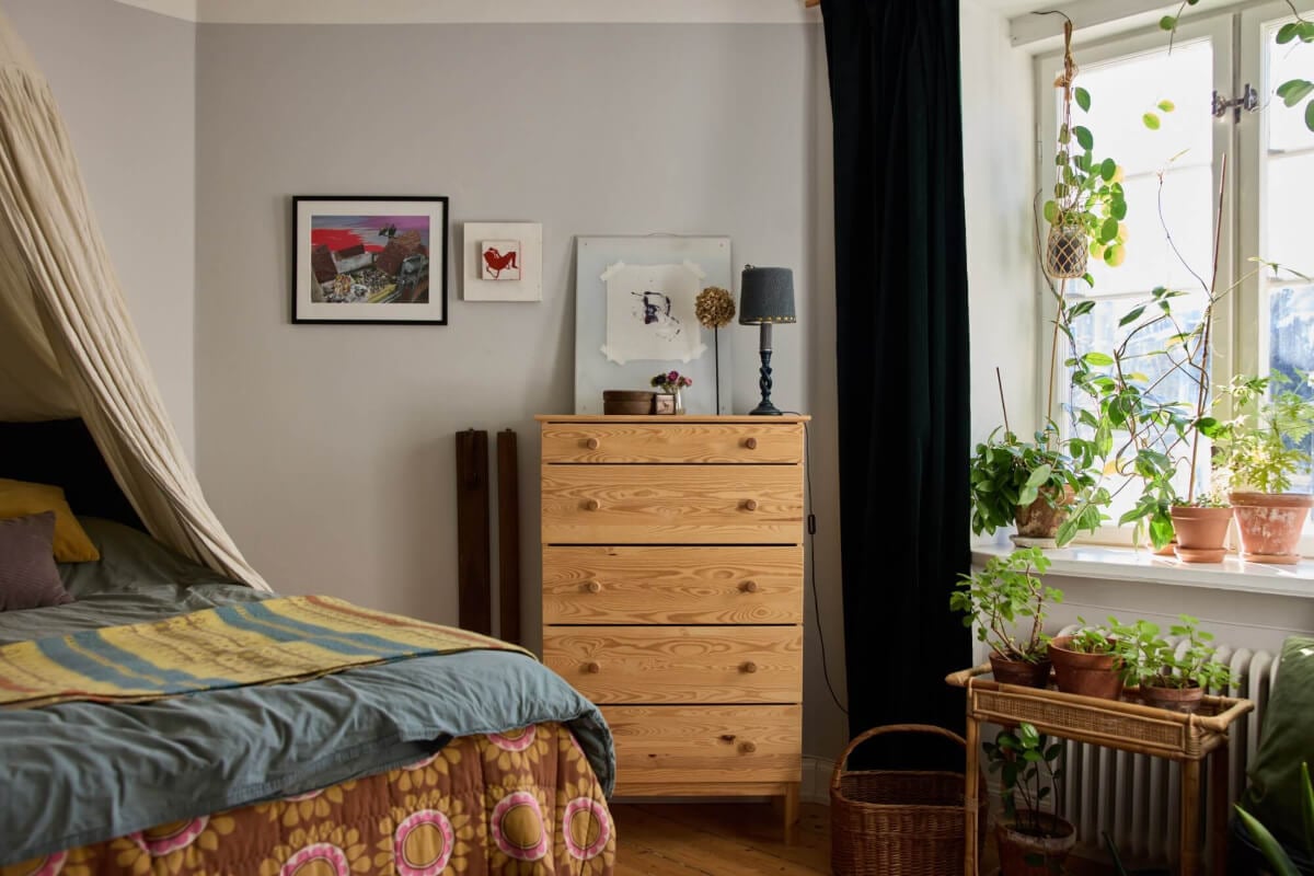 A Charming Apartment with Period Details in Malmö 7 bedroom with layered textiles ikea dresser