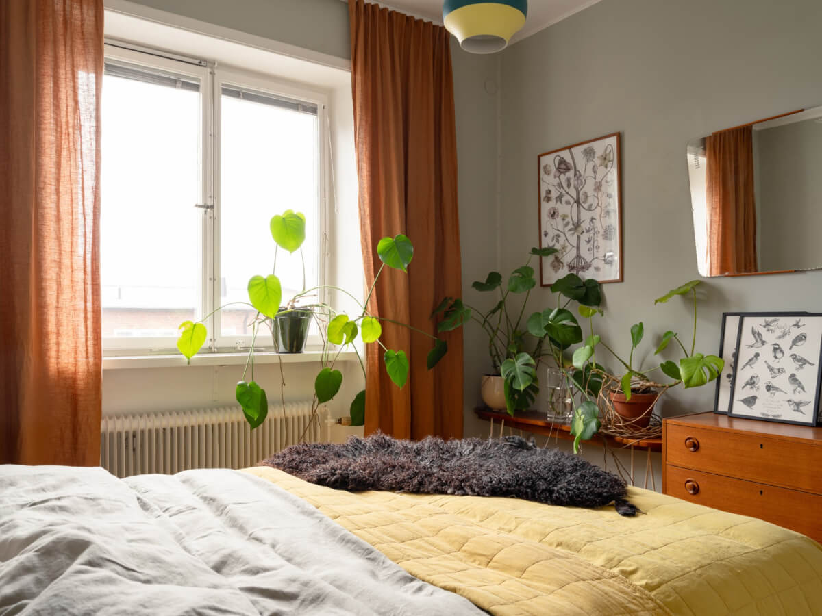Colorful Wallpapers in a Well-Planned 1940s Apartment 17 bedroom with plants