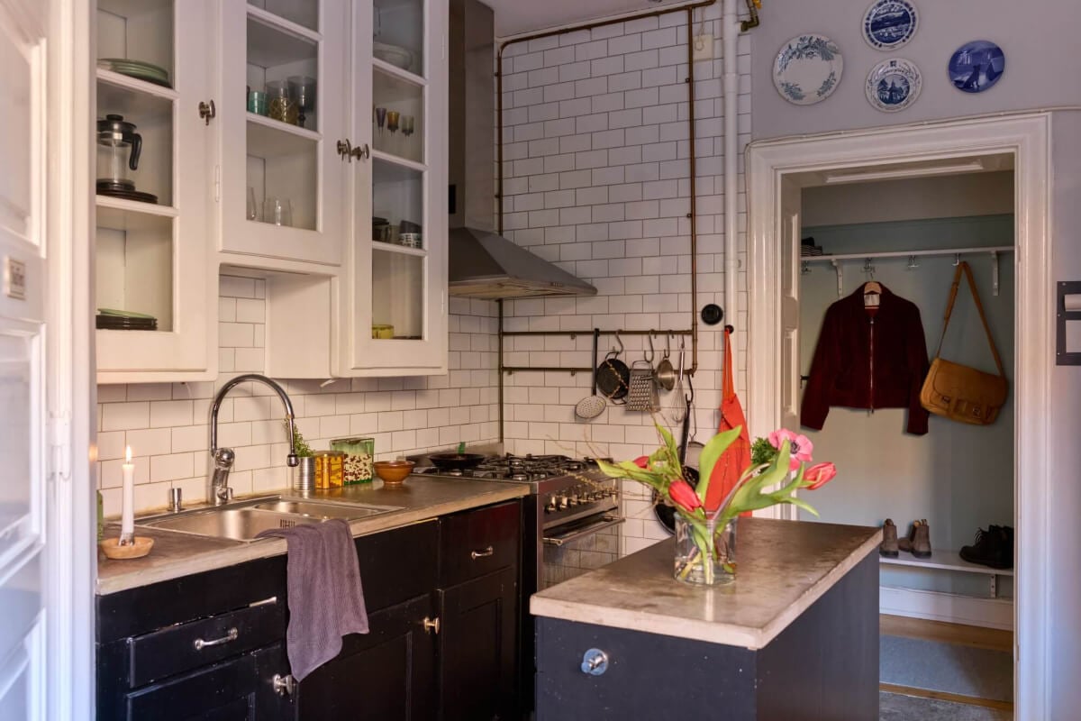 A Charming Apartment with Period Details in Malmö 13 black and white kitchen concrete worktop