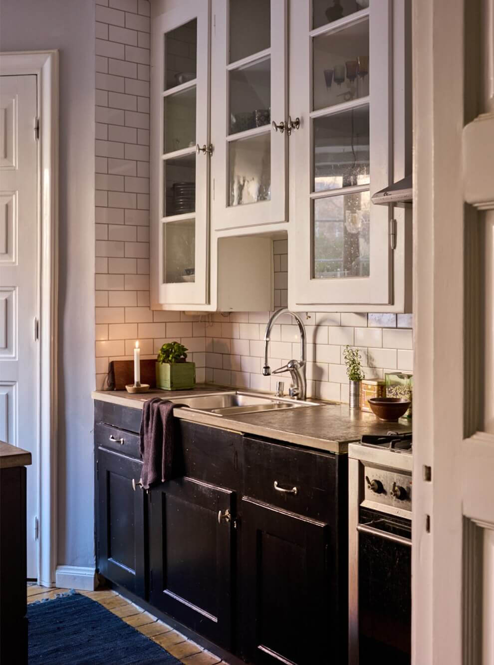 A Charming Apartment with Period Details in Malmö 11 black and white kitchen glass cabinets