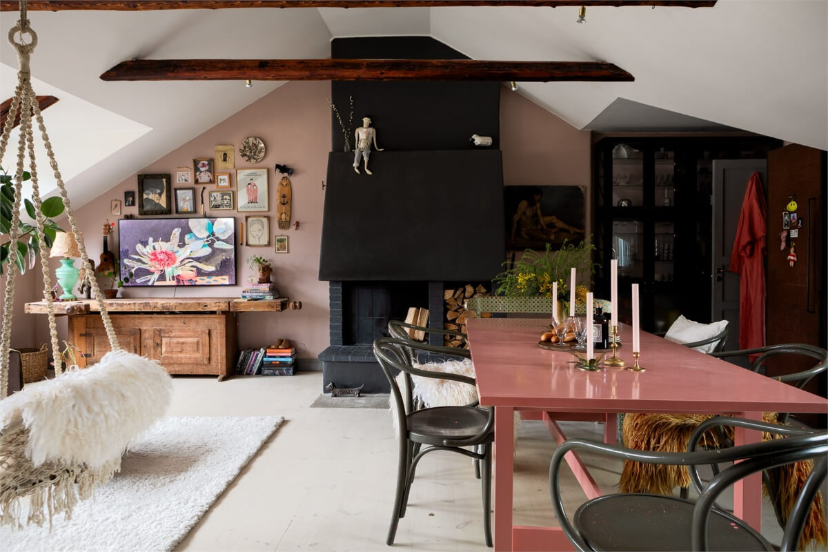 A Colorful Family Attic Apartment in Stockholm 4 black fireplace and pink dining table