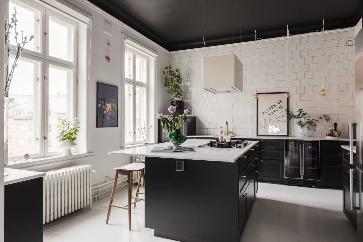 Grand Rooms and Period Features in a Malmö Apartment 13 black kitchen with island and black ceiling