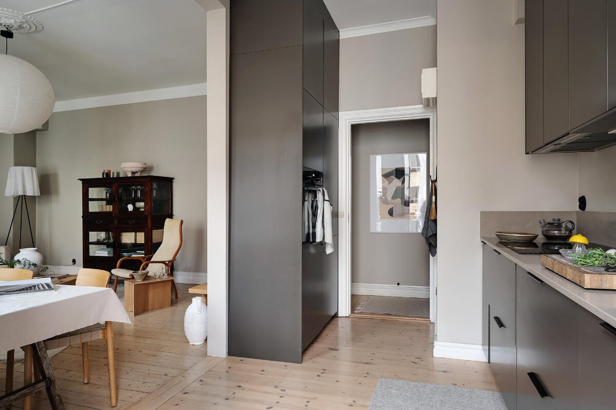 A Gothenburg Apartment with a Small Dark Green Bedroom 19 black kitchen wooden floor