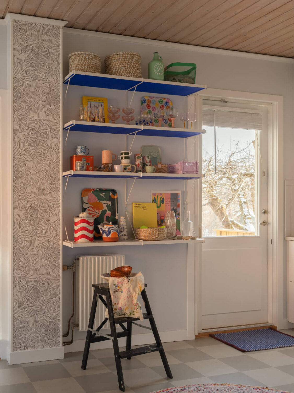 Colorful Decor in a Charming Family Duplex Apartment in Stockholm 12 blue and white kitchen shelves