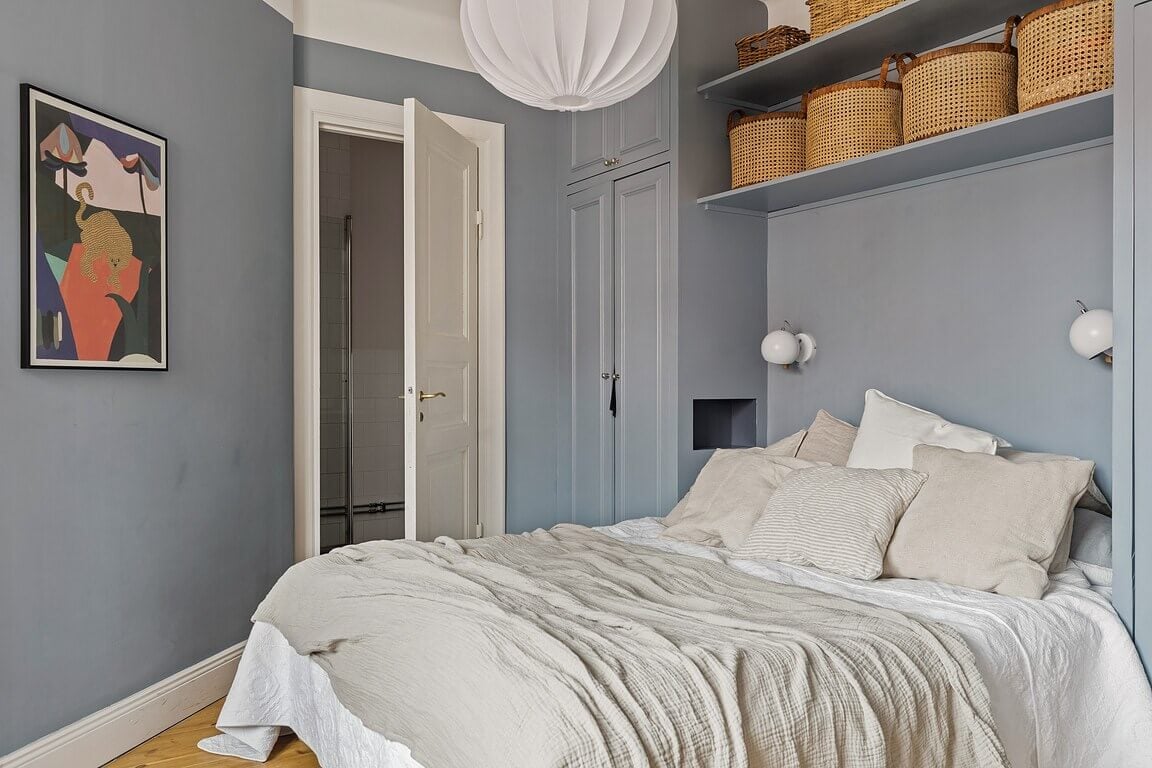 A Stockholm Apartment with a Light Yellow Kitchen 17 blue bedroom built-in wardrobe and shelves