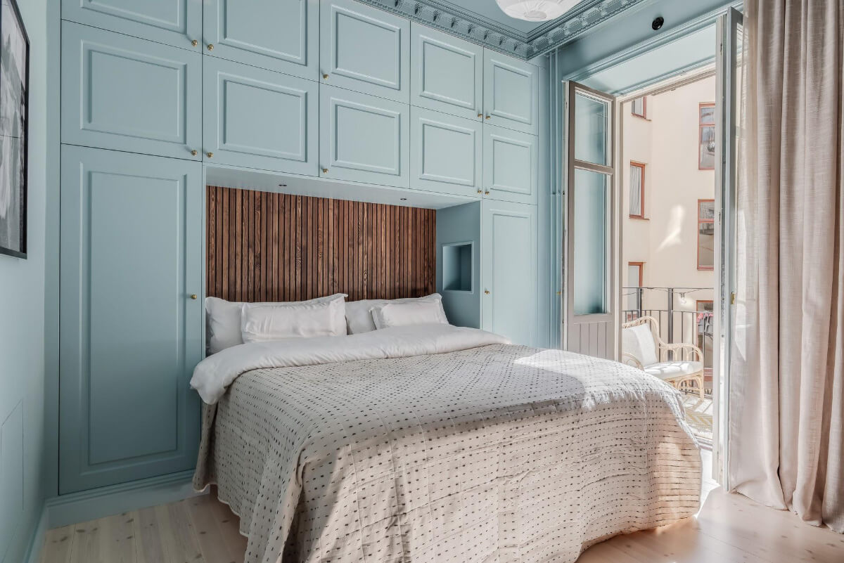 Pastel Colors and Contemporary Design in a Late 19th Century Apartment 14 blue bedroom with wardobes around the bed