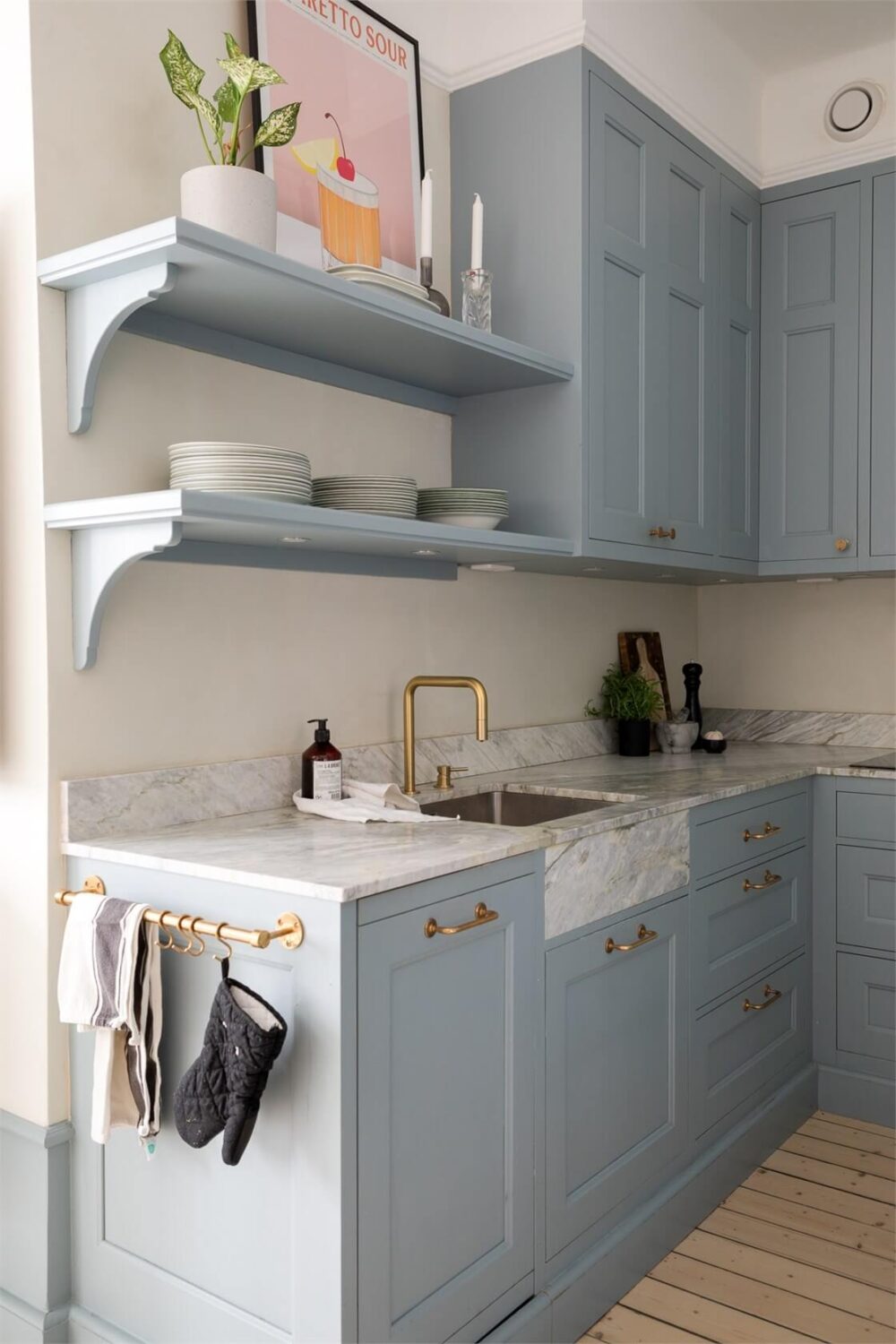 A Small Stockholm Apartment with a Blue Shaker Kitchen 15 blue cabinets kitchen with shelves