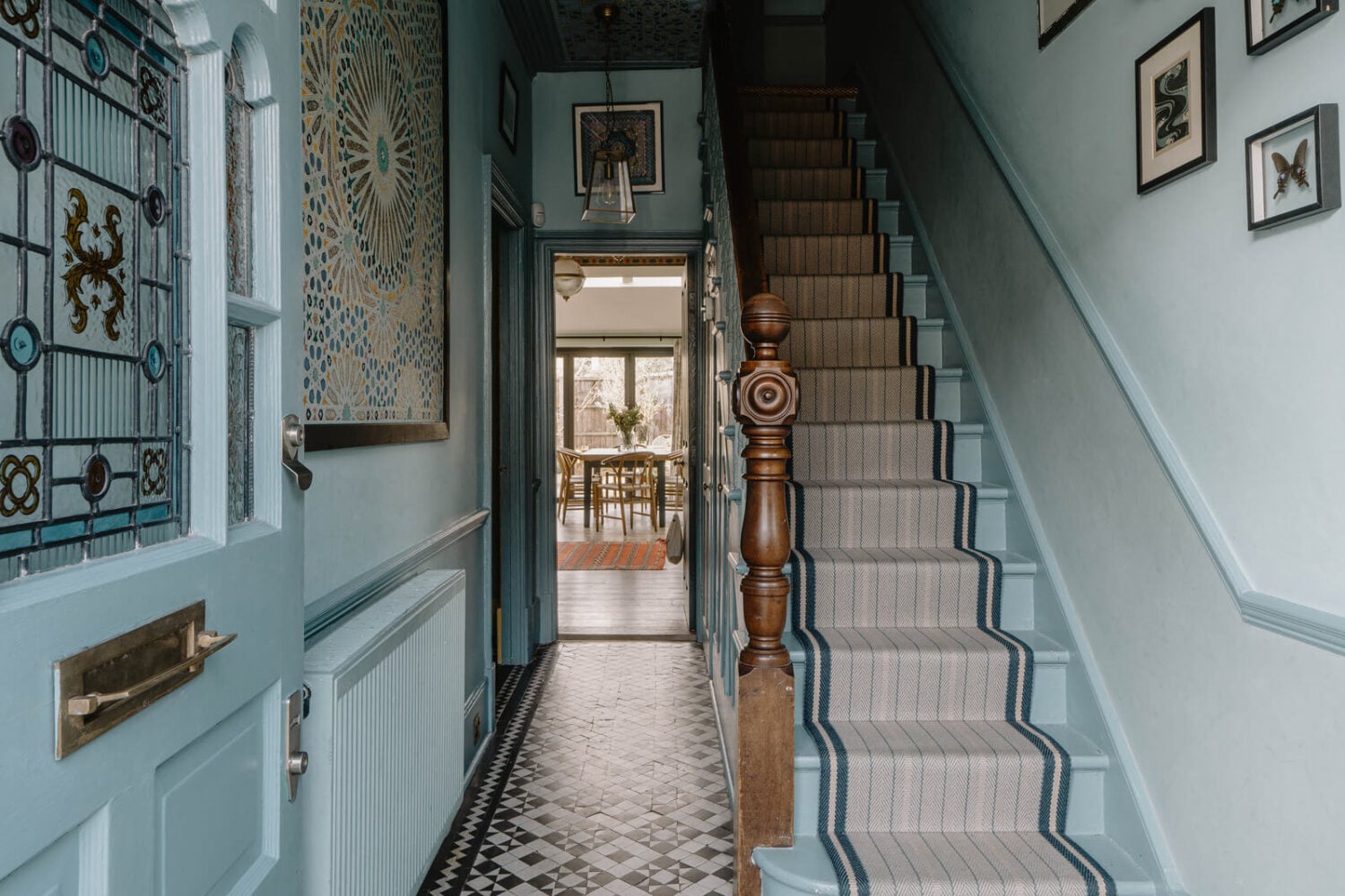 Moroccan-Inspired Designs in a Unique Artist Family Home in London 17 blue hall with floor tiles and painted ceiling
