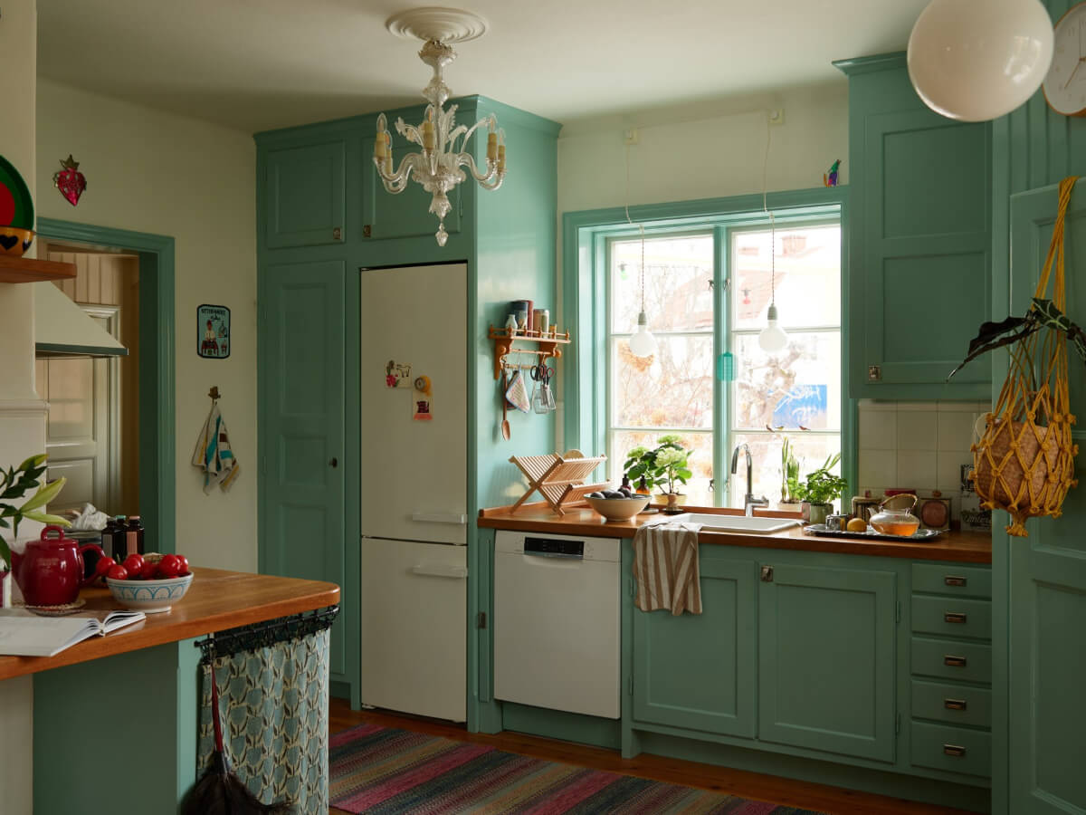 Colorful Interiors in a Wonderful Early 20th Century Swedish Villa 9 blue kitchen reclaimed cabinets