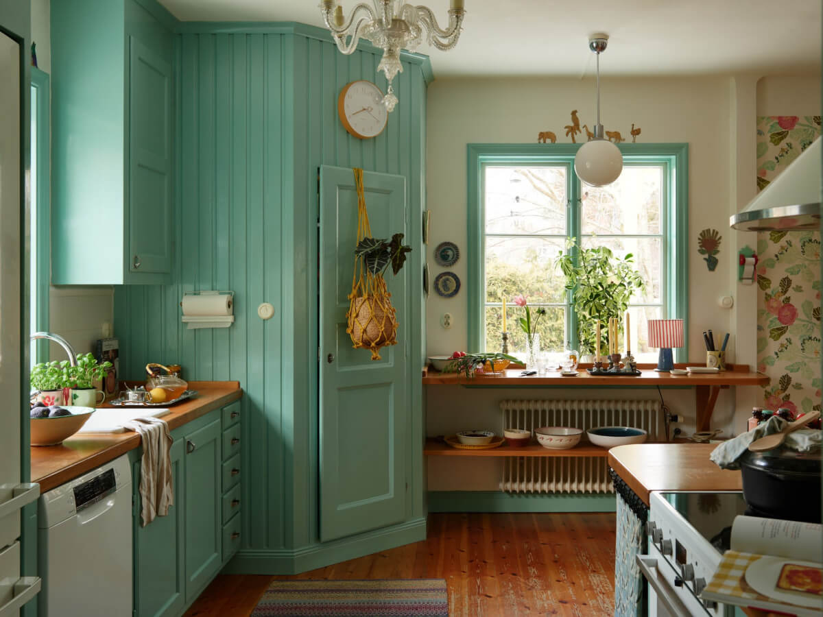 Colorful Interiors in a Wonderful Early 20th Century Swedish Villa 6 blue kitchen shelves under window