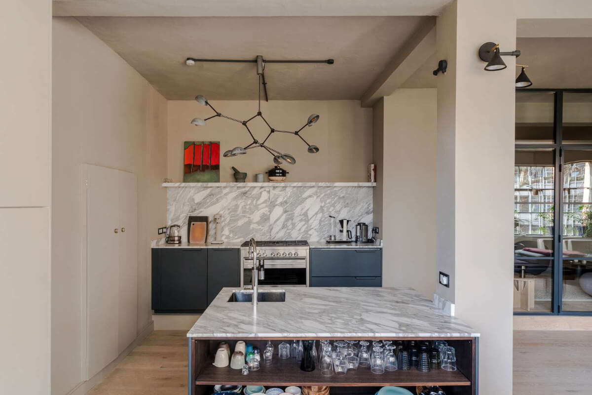 Soft-Colored Contemporary Interiors in a Warehouse Apartment 13 blue kitchen with island