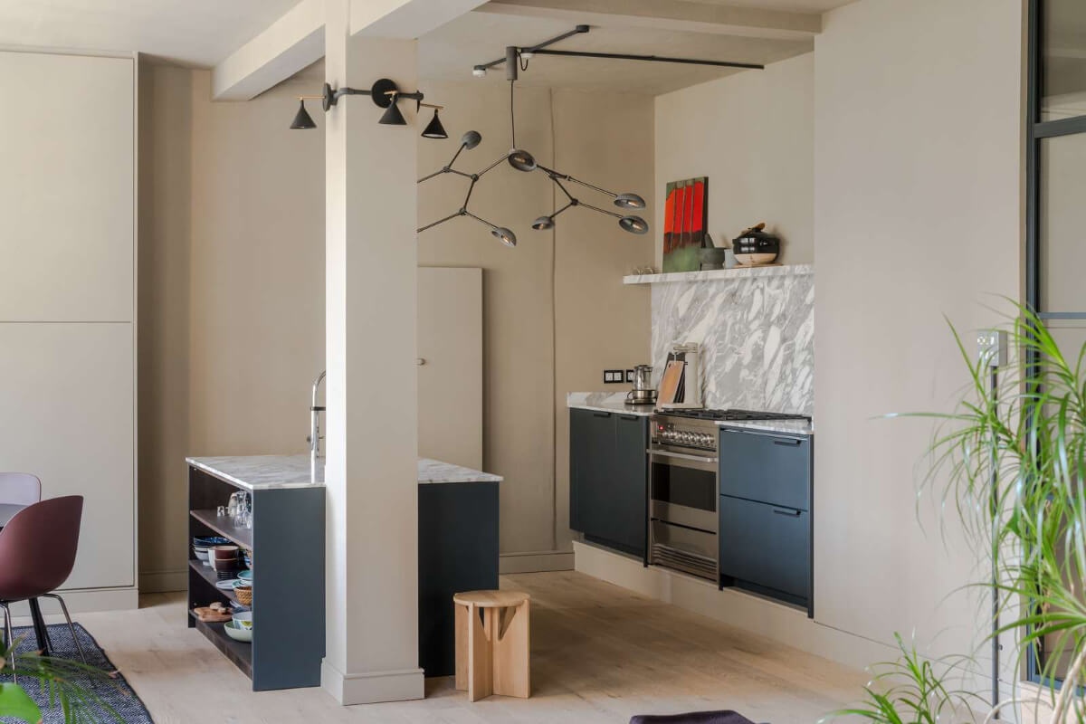 Soft-Colored Contemporary Interiors in a Warehouse Apartment 11 blue open plan kitchen with island