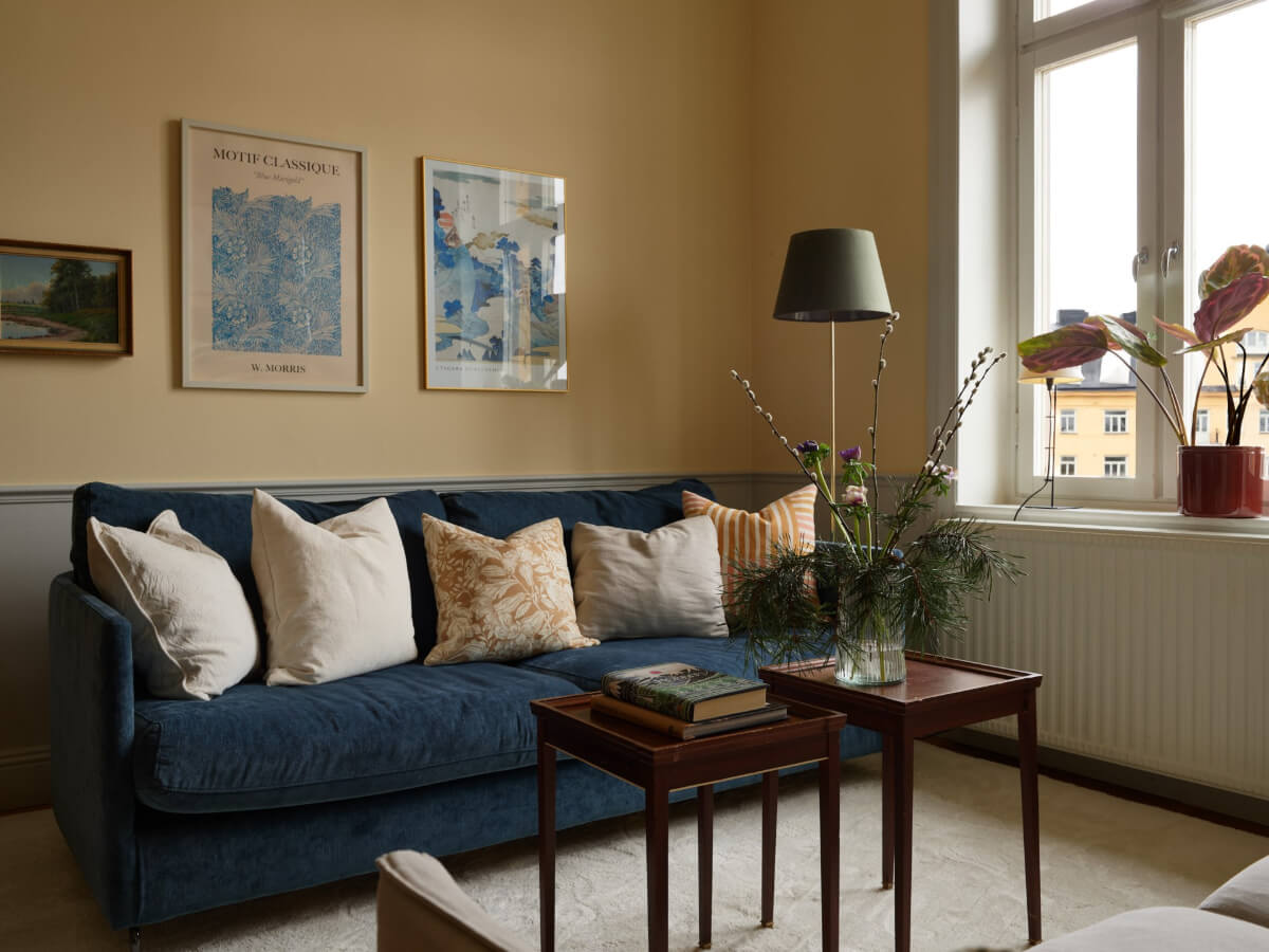 Lovely Color Combinations in a Charming One-Bedroom Apartment 5 blue sofa yellow living room
