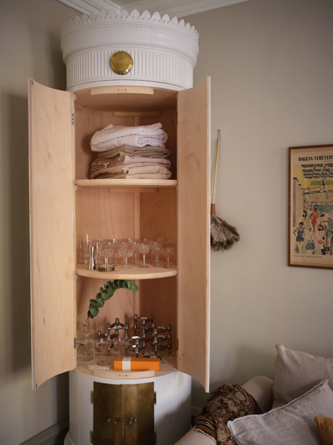 A Charming Vintage Apartment with Historic Wallpapers in Stockholm 5 bookcase in shape of kakelugn
