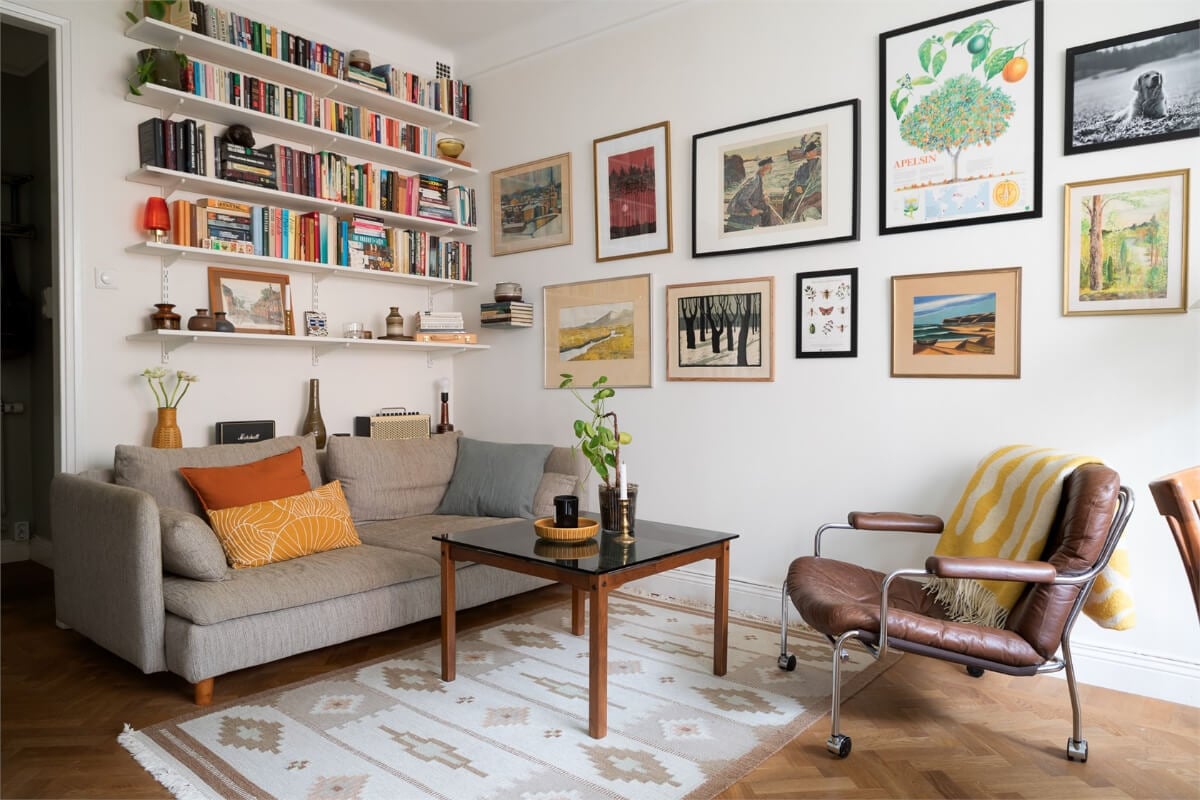 A Small Open-Plan Apartment with Midcentury Furniture 3 bookshelves and art living room