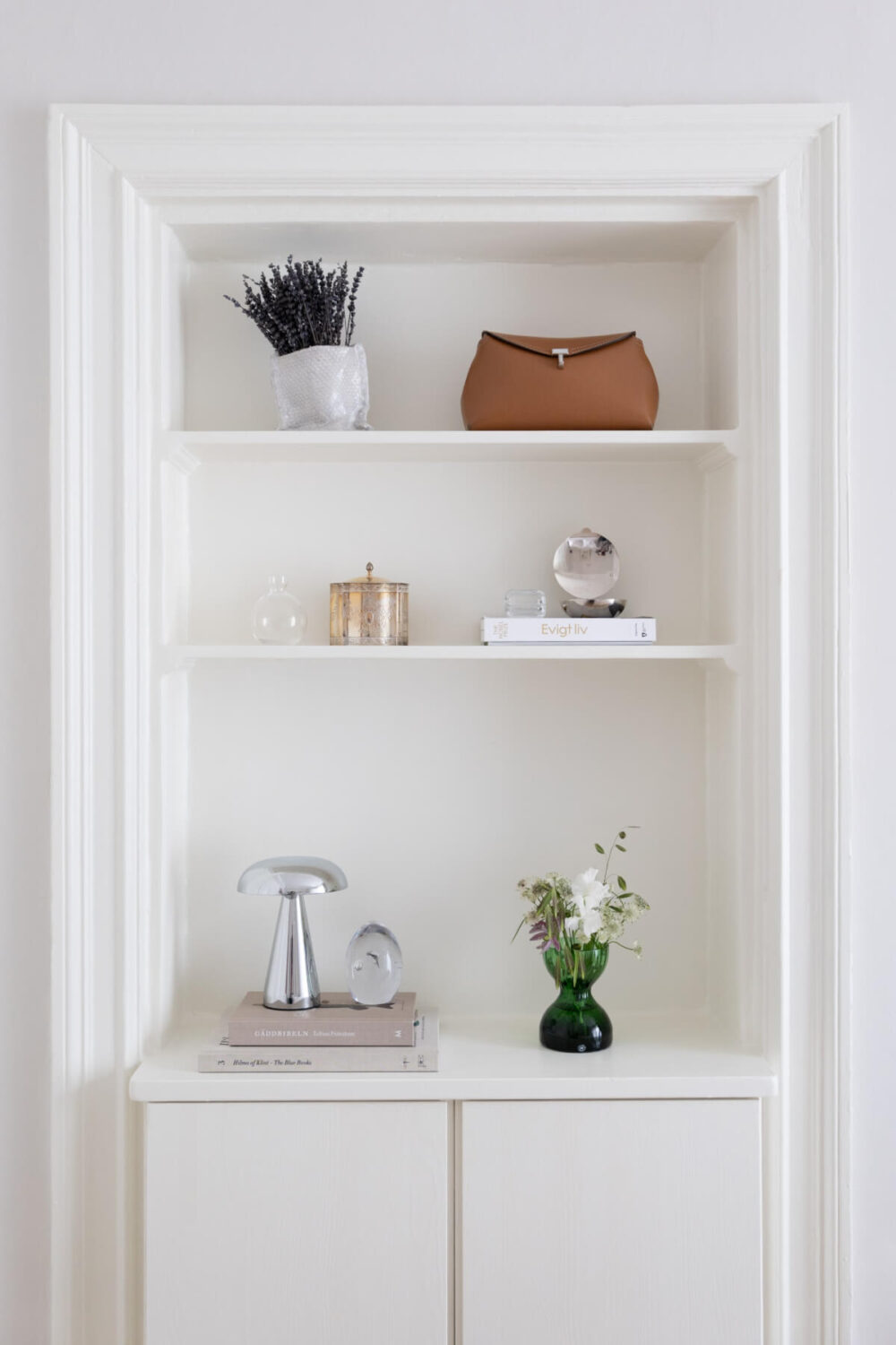 A Small Apartment Decorated in a Light Gray & White Color Palette 19 built in shelves and cabinets