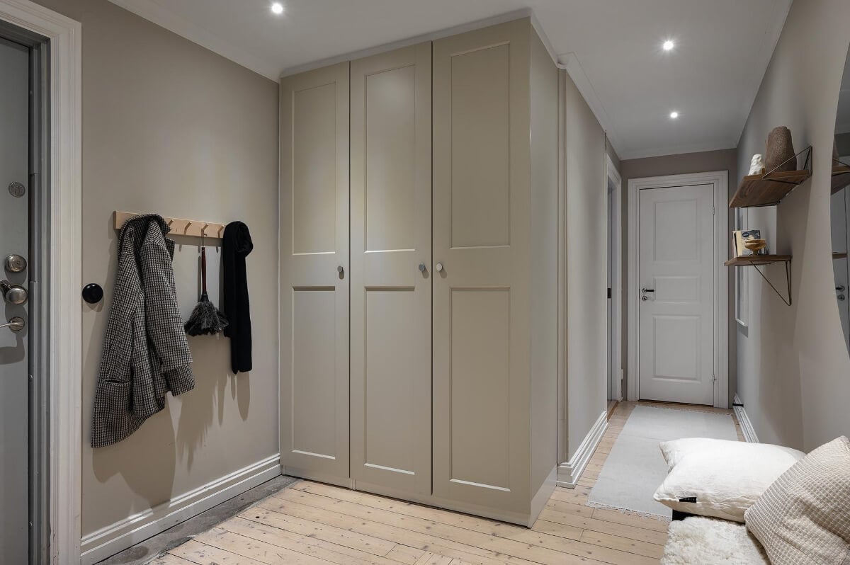 A Gothenburg Apartment with a Small Dark Green Bedroom 26 built-in storage hallway