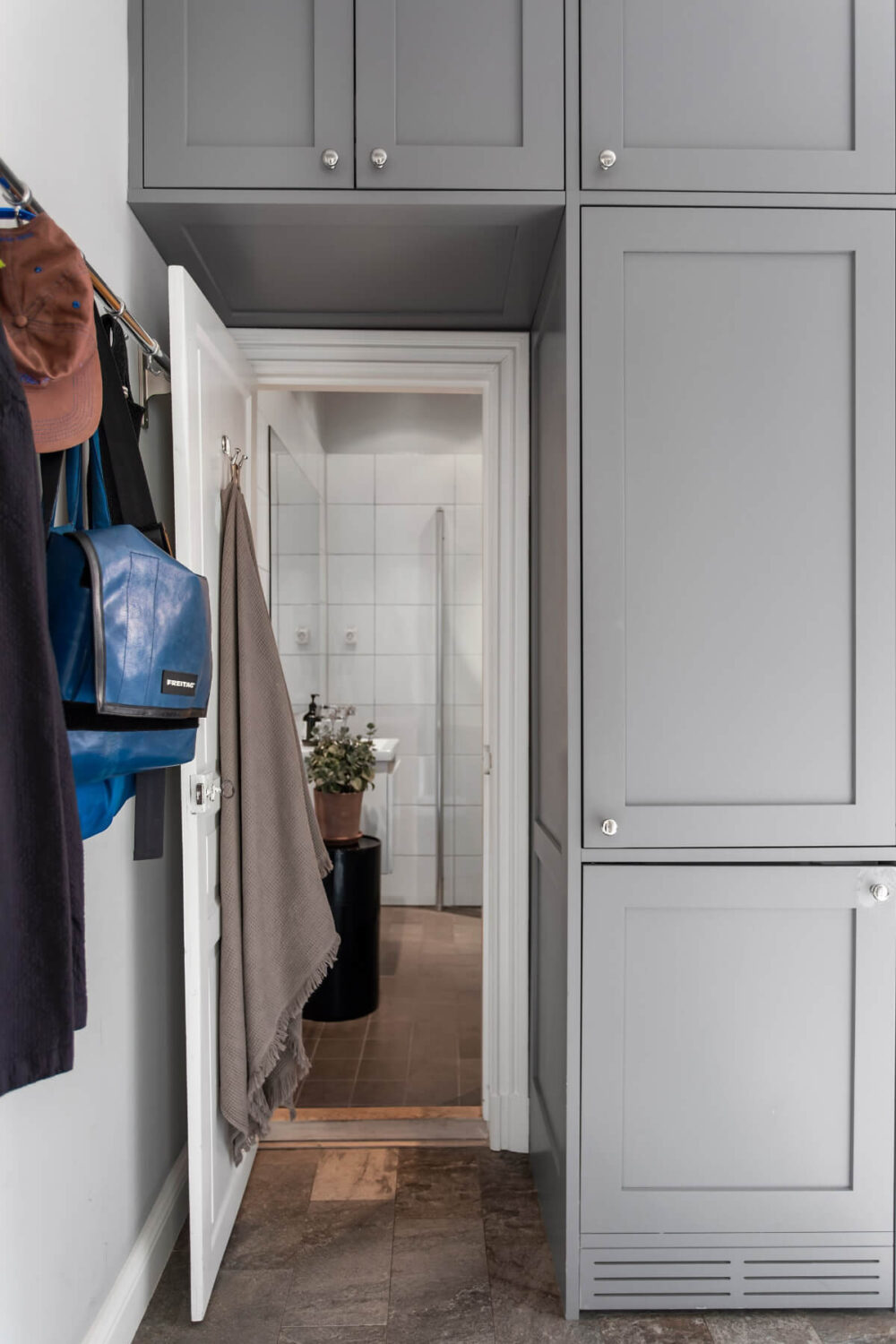 A Gray Studio Apartment with an Industrial Room Divider 15 cabinets over doorway