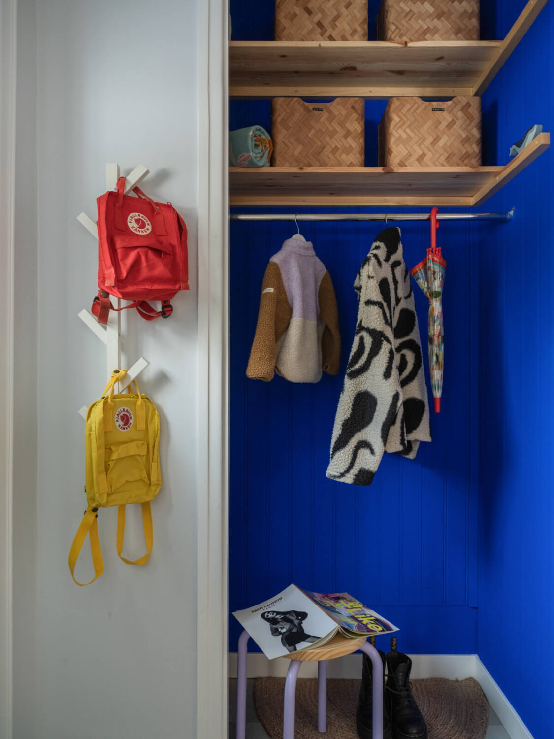 Colorful Decor in a Charming Family Duplex Apartment in Stockholm 31 cobalt blue storage niche hall