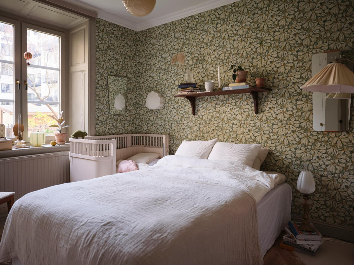 A Charming Vintage Apartment with Historic Wallpapers in Stockholm 11 combined bedroom with nursery green wallpaper
