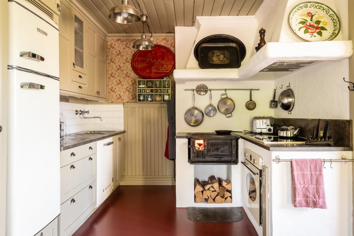 A Beautiful Historic Swedish Country House with Wallpapers 8 country kitchen original oven wallpaper red floor