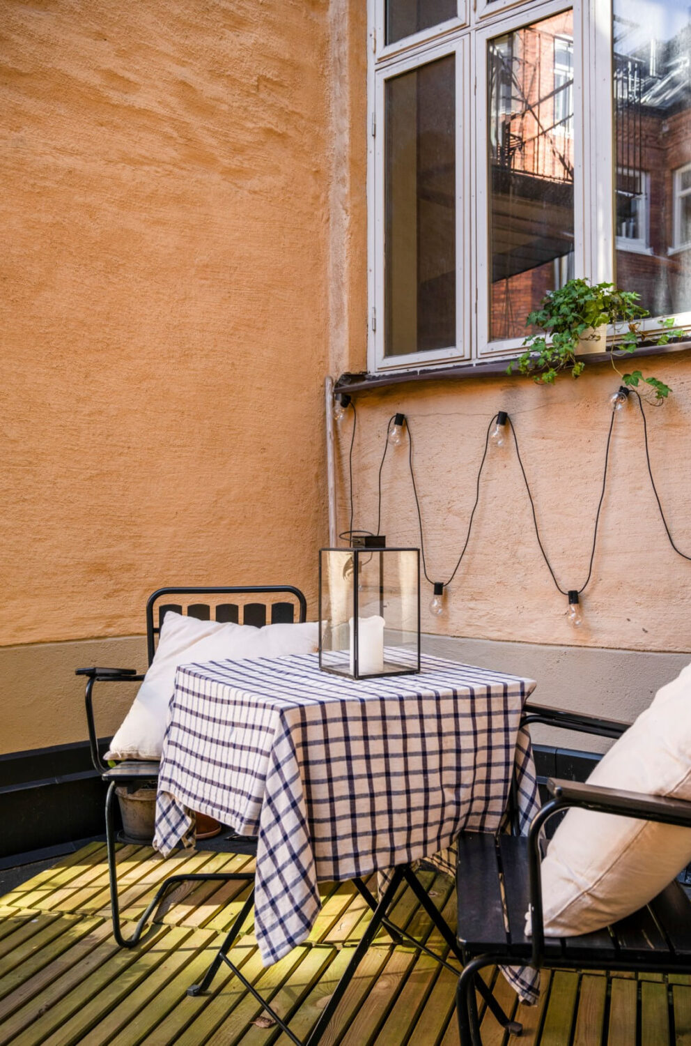 A Cozy Small Apartment with Period Features and Lots of Storage 15 courtyard terrace string lights