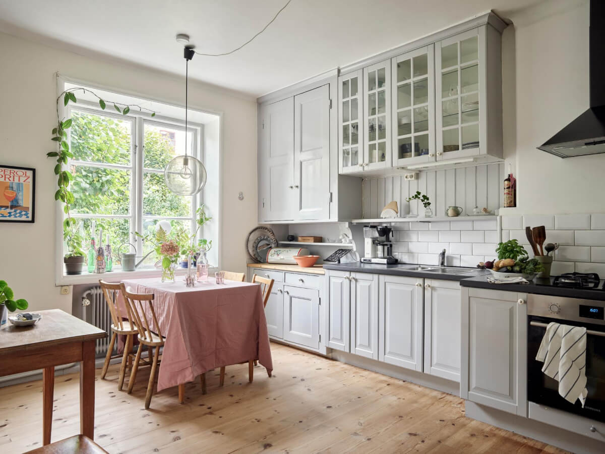 A Pink Ground Floor Studio Apartment with a Large Kitchen 8 cozy gray kitchen wooden floor large window