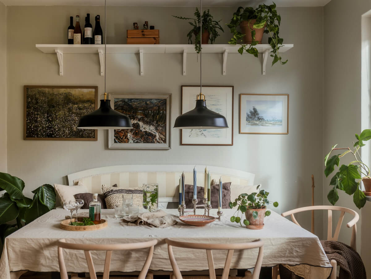 Cozy Plant-Filled Interiors in a 1940s Apartment 14 cozy kitchen dining nook with bench