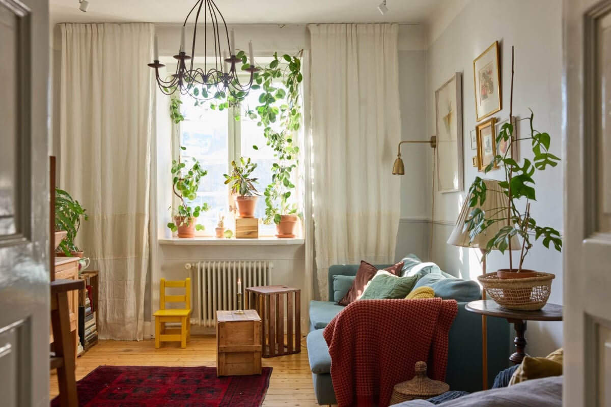 A Charming Apartment with Period Details in Malmö 1 cozy living room wooden floor plants