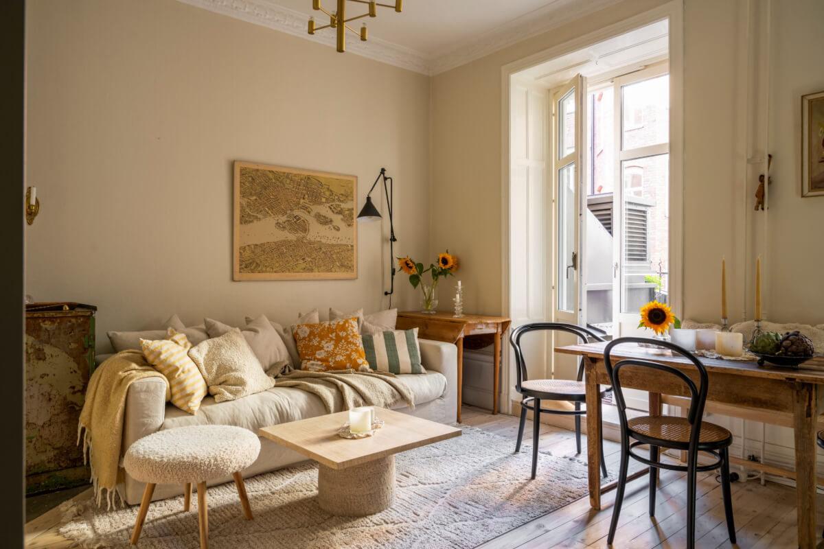 A Cozy Small Apartment with Period Features and Lots of Storage 2 cozy small beige living room rug vintage wooden tables
