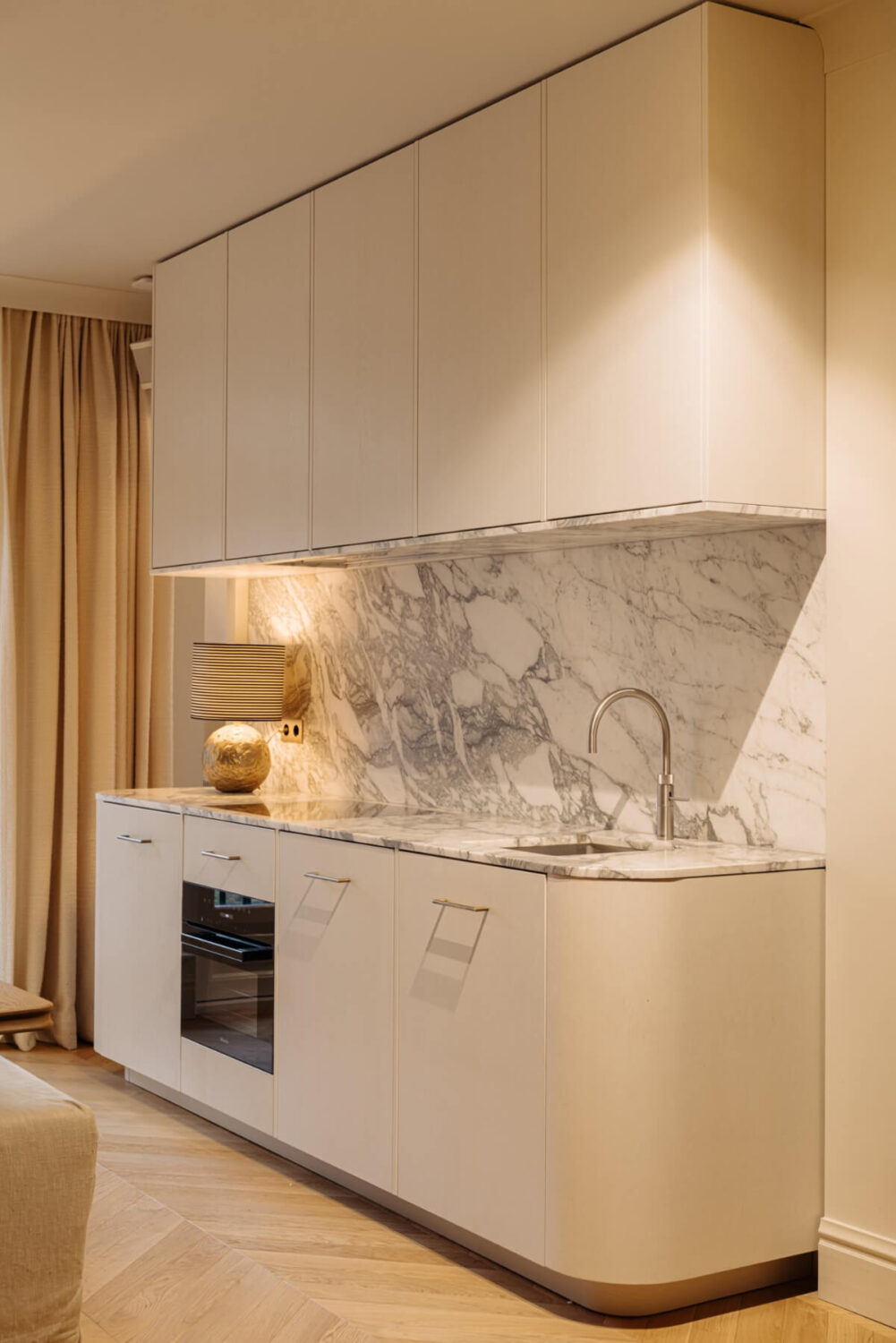 A Luxurious Apartment in Amsterdam with a Lovely Master Suite 5 curved white kitchen marble countertop backsplash