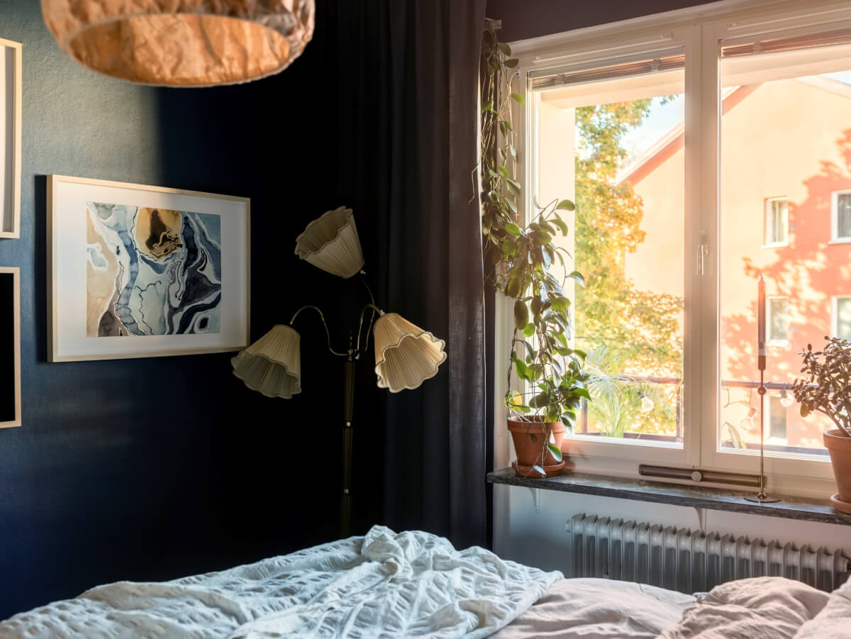 Cozy Plant-Filled Interiors in a 1940s Apartment 18 dark blue bedroom large window