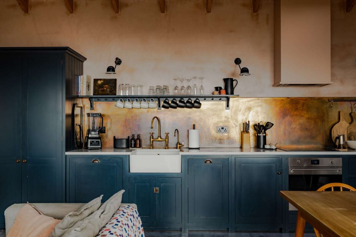 A Japanese-Inspired Timber Home with Views of a Lush Valley 3 dark blue devol kitchen brass backsplash butler sink