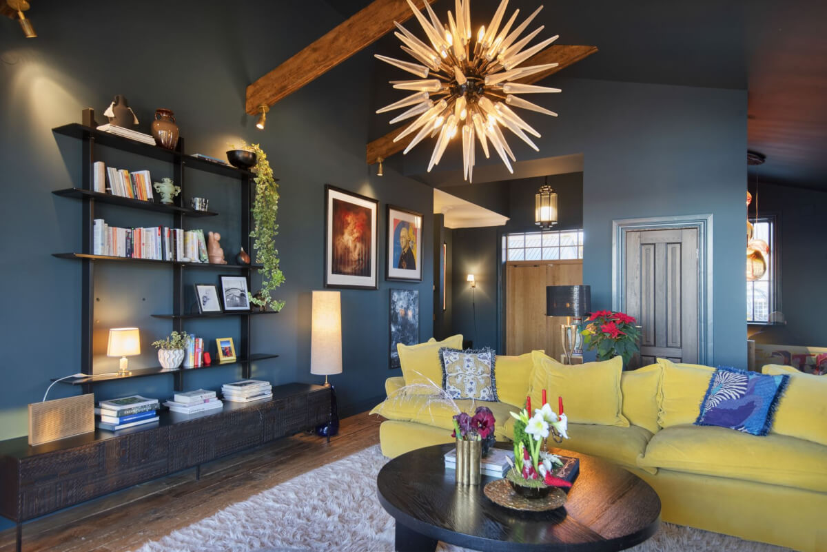 English Manor Style Interiors in a New Swedish Home with Lake Views 3 dark blue living room exposed wooden beams