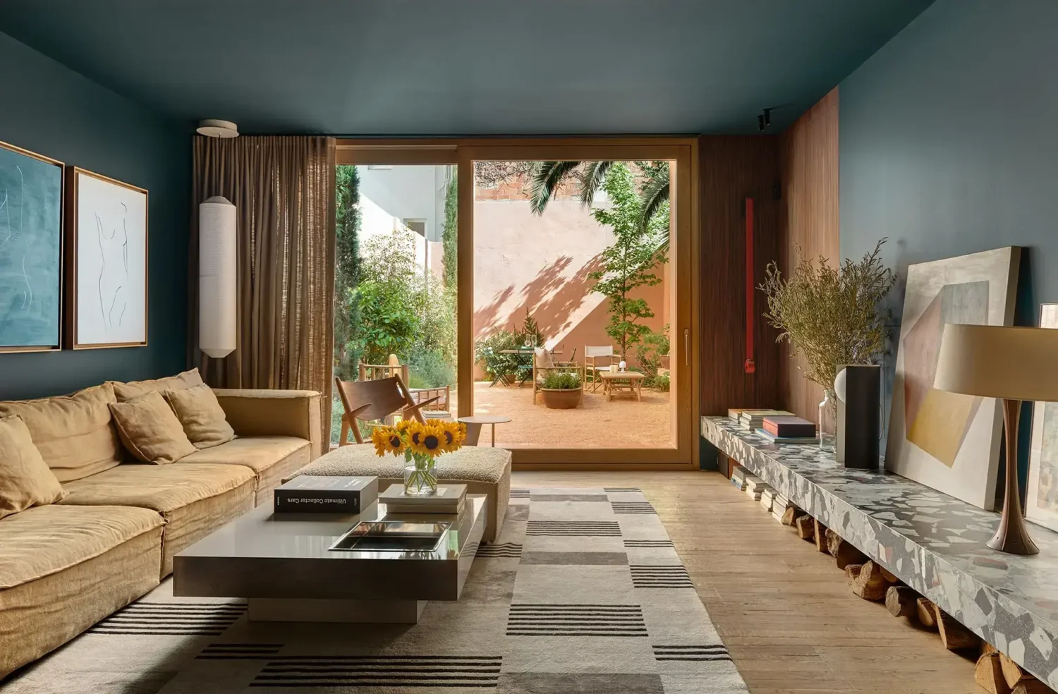 Colorful Contemporary Interiors in a 1930s Spanish House 1 dark blue living room terrazzo bench