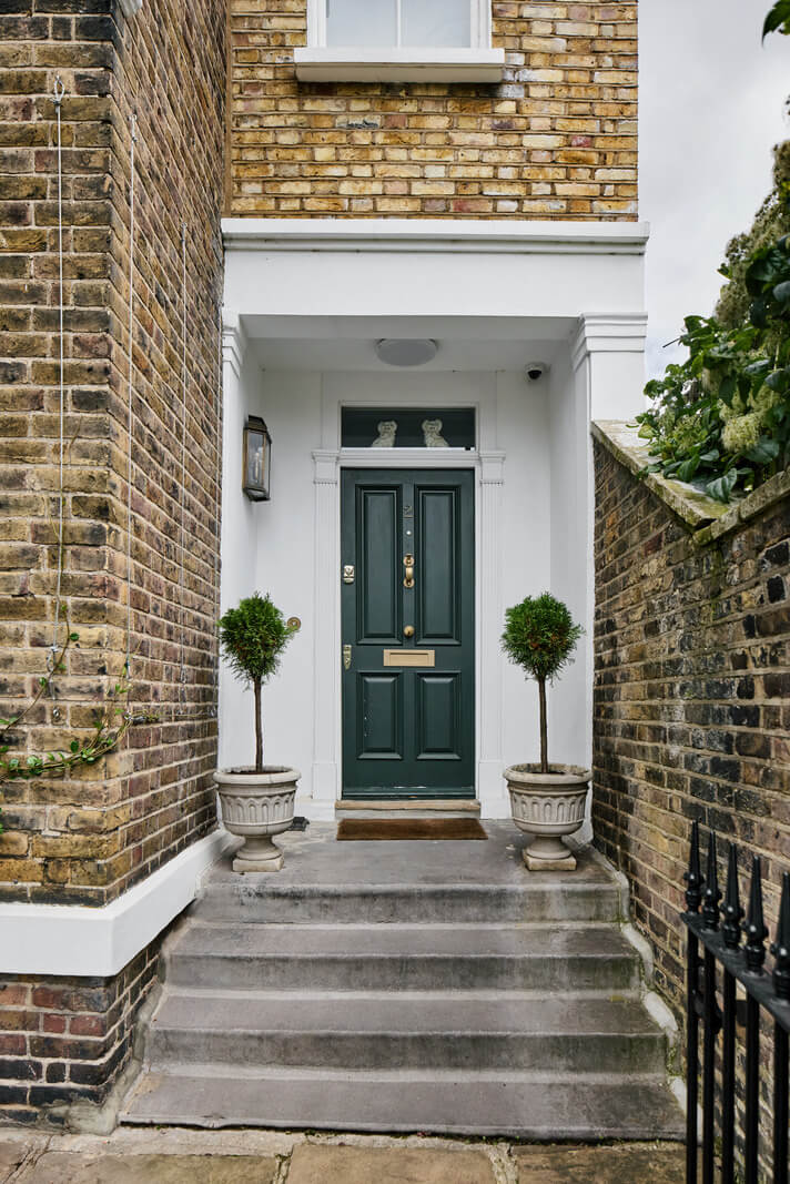 A Renovated Early Victorian Townhouse Decorated in Green Tones 27 dark green front door